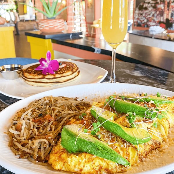 A breakfast spread with an omelet, hash browns, pancakes, and a mimosa at The Reserve.