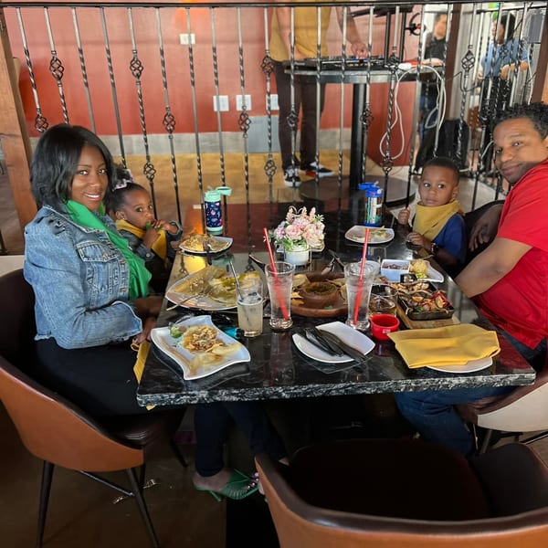 A family of four, including two young children, enjoys a meal at a Mexican restaurant.